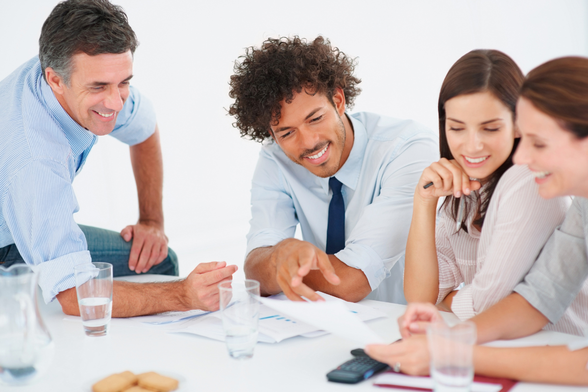 Four people collaborate on business writing
