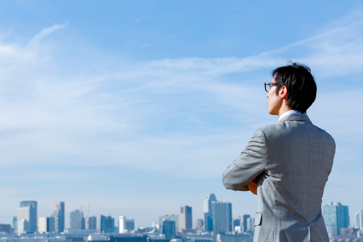 A thought leader gazes out over a cityscape