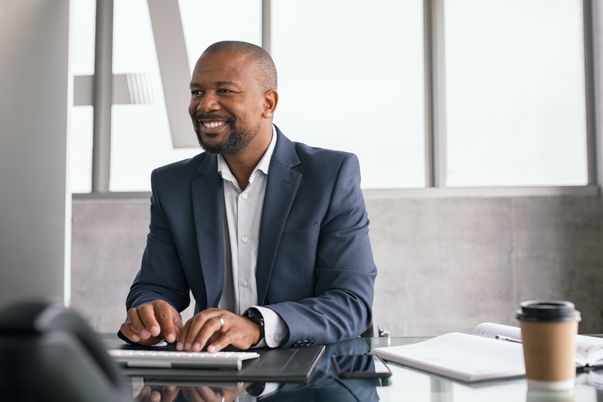 An executive writes thought leadership content on a computer