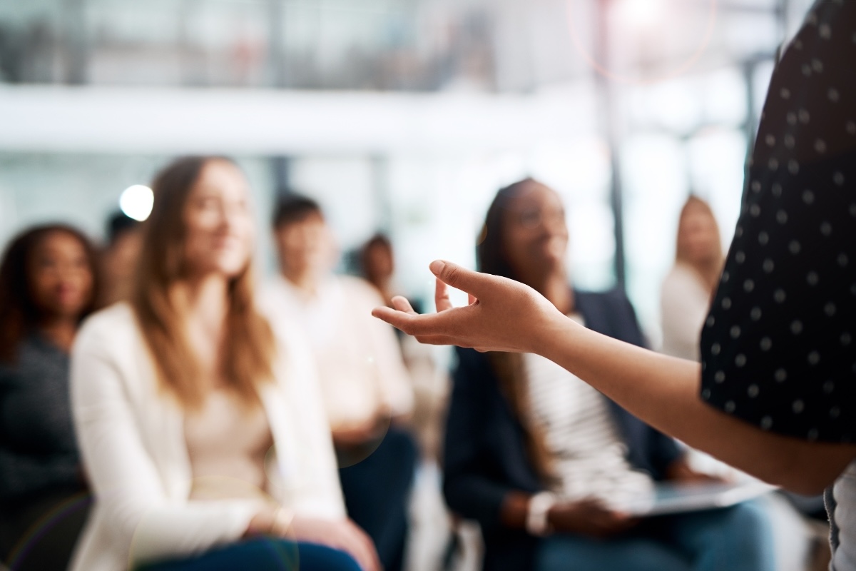 A person presents in front of an interested audience