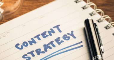 The words "content strategy" written on a notebook with a lightbulb next to it