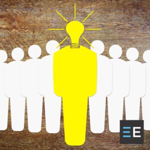 Paper cut outs of people; a yellow one with a lightbulb head is in front of the others