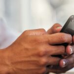 A person typing on their phone