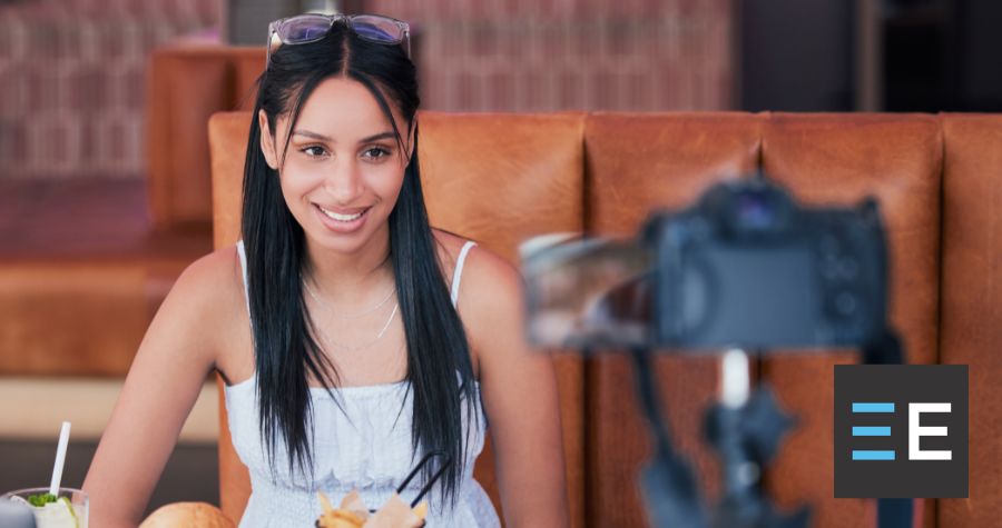 A person smiling in front of a video camera