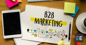 A piece of paper in a cluttered desk with the words "B2B Marketing" on it